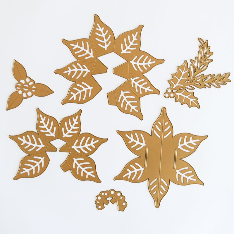 a group of cut outs of leaves and berries.