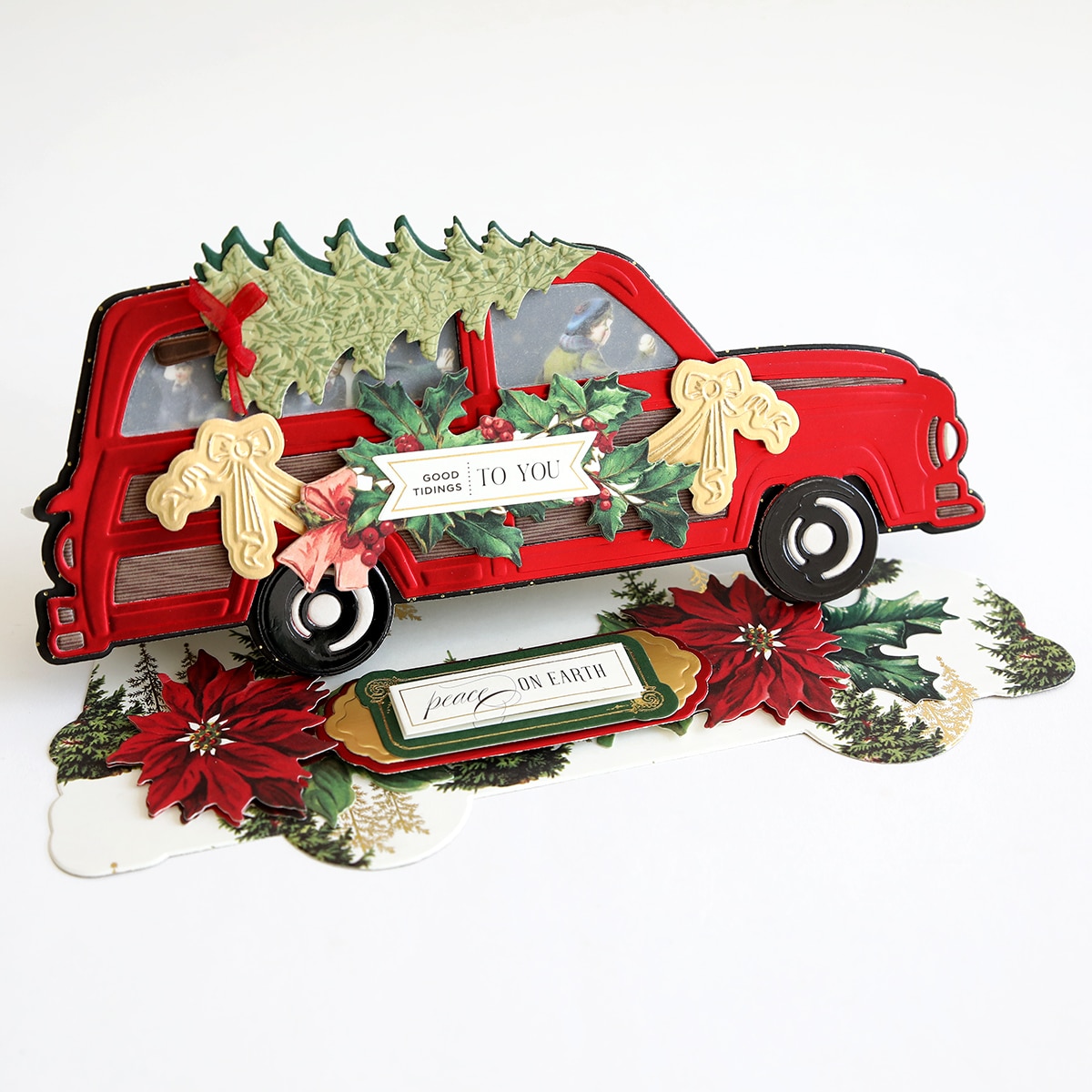 a red truck decorated with poinsettis and christmas decorations.