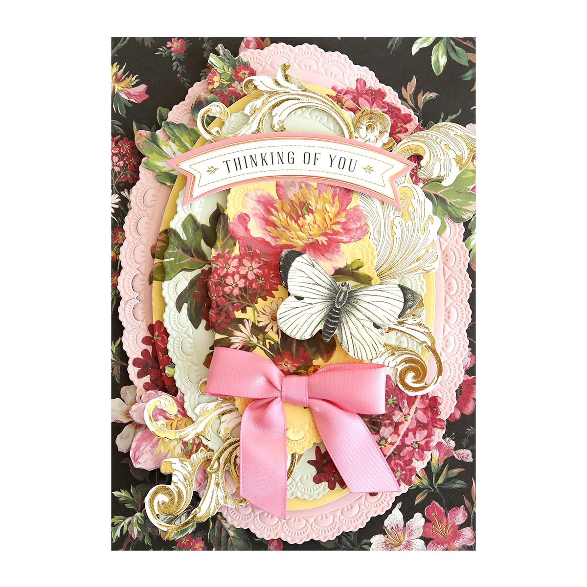 a card with a pink bow and flowers.