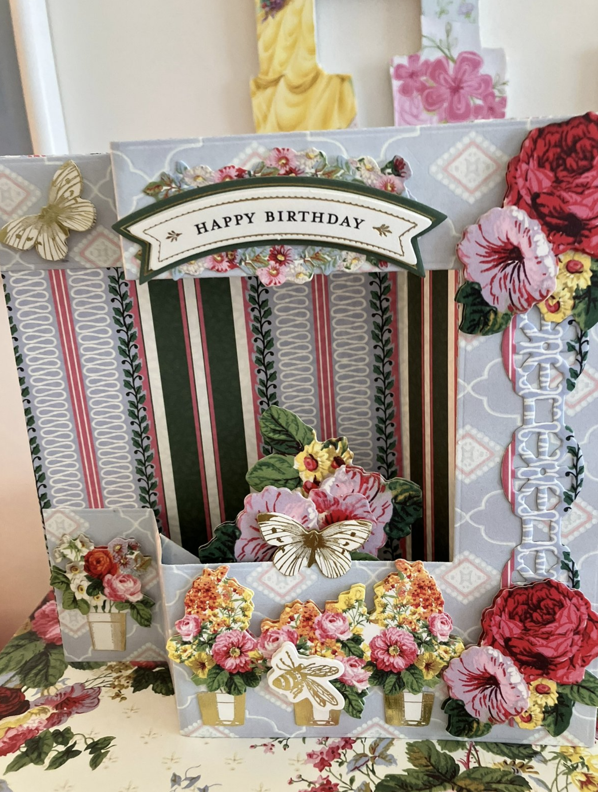 a birthday card with a bunch of flowers on it.