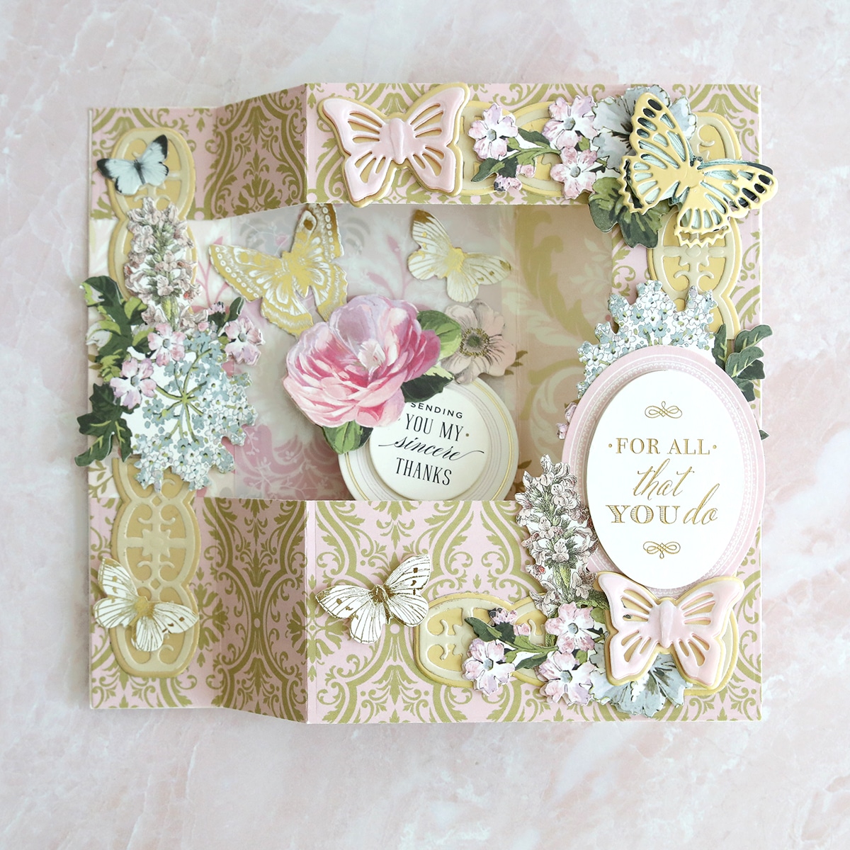 a close up of a card with flowers and butterflies.