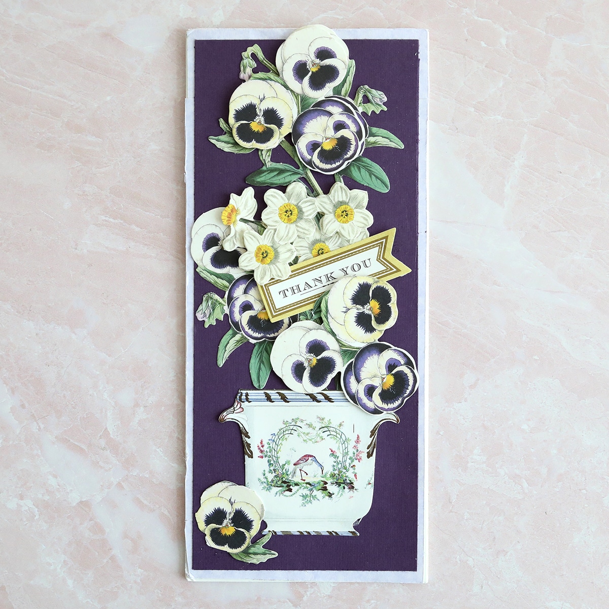 a card with flowers on a purple background.