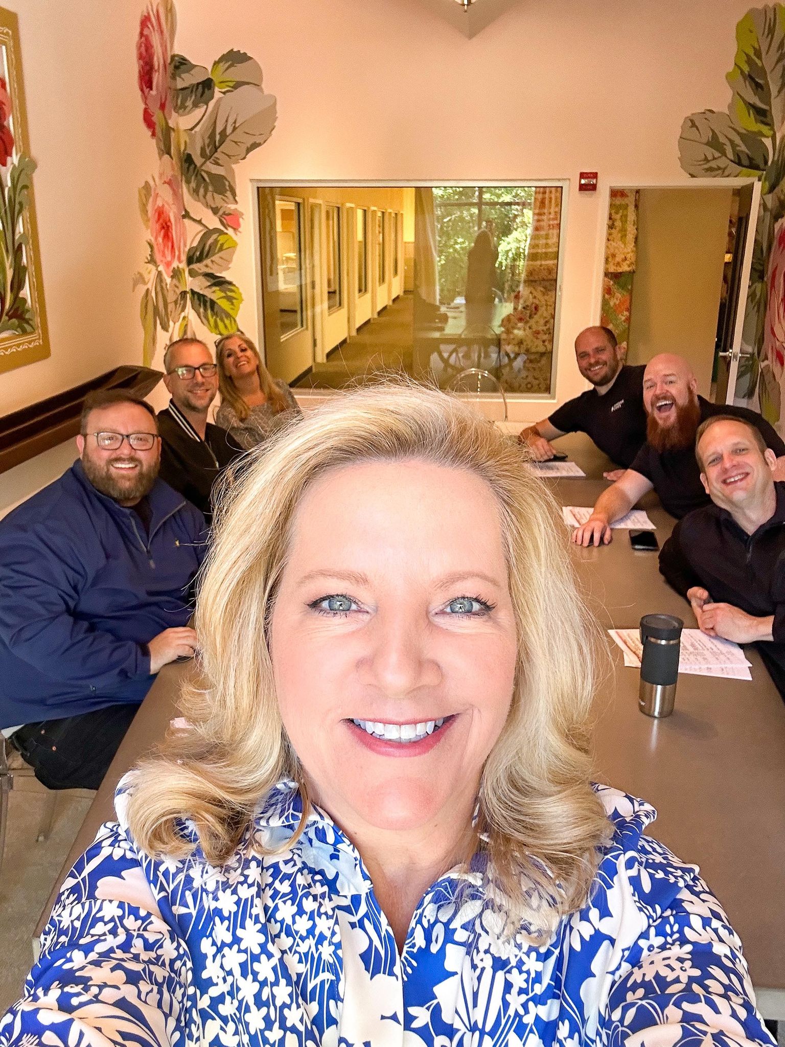 a group of people sitting around a table.