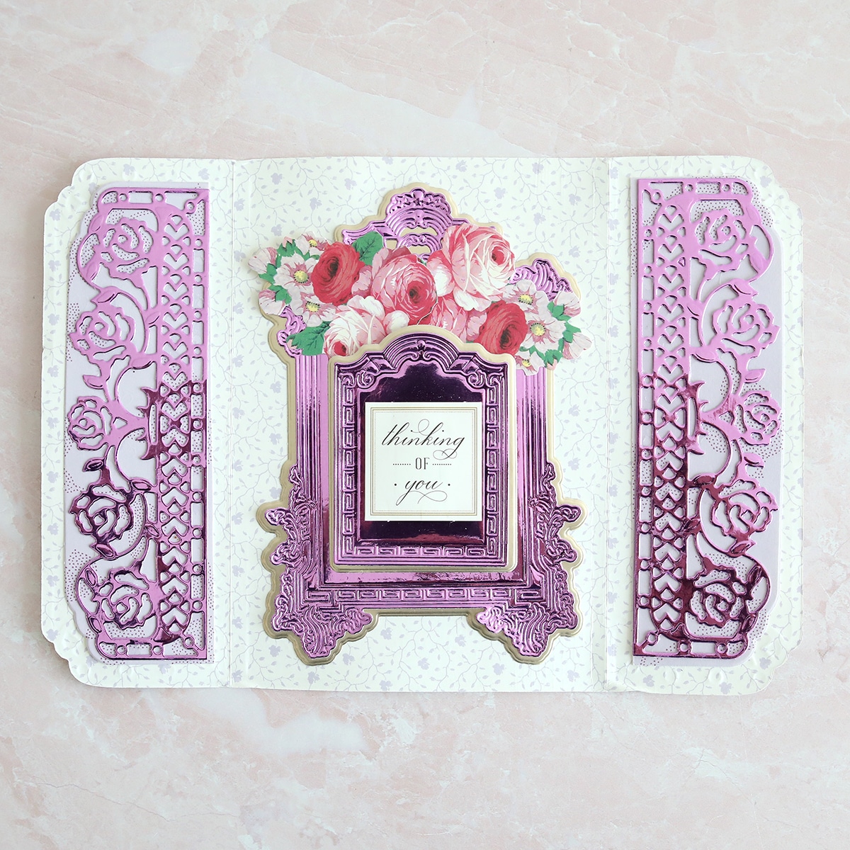 a card with a picture frame and flowers on it.