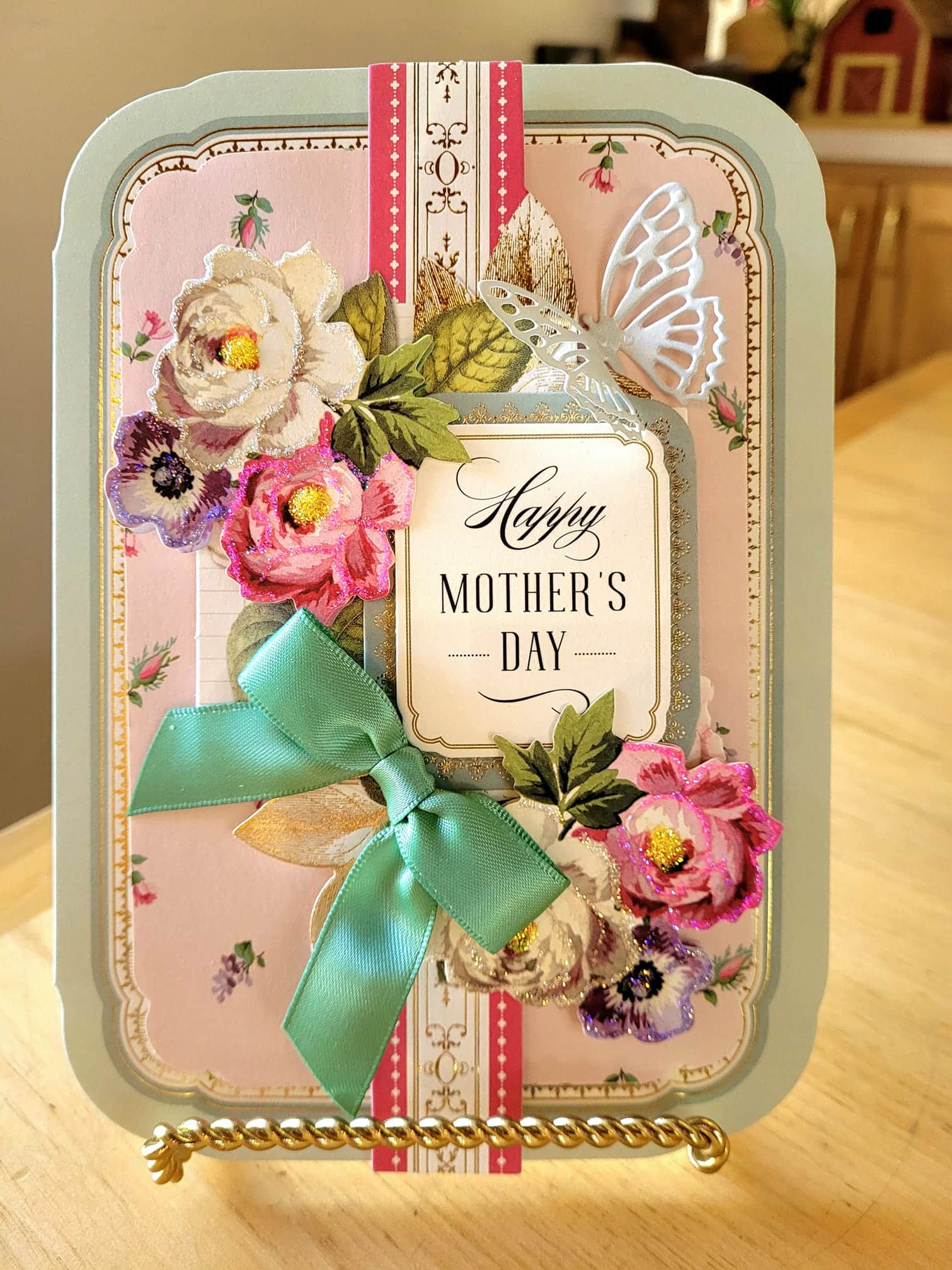 a mother's day card with flowers and a butterfly.