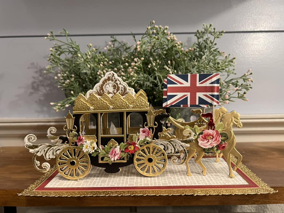 a horse drawn carriage with a flag on top of it.