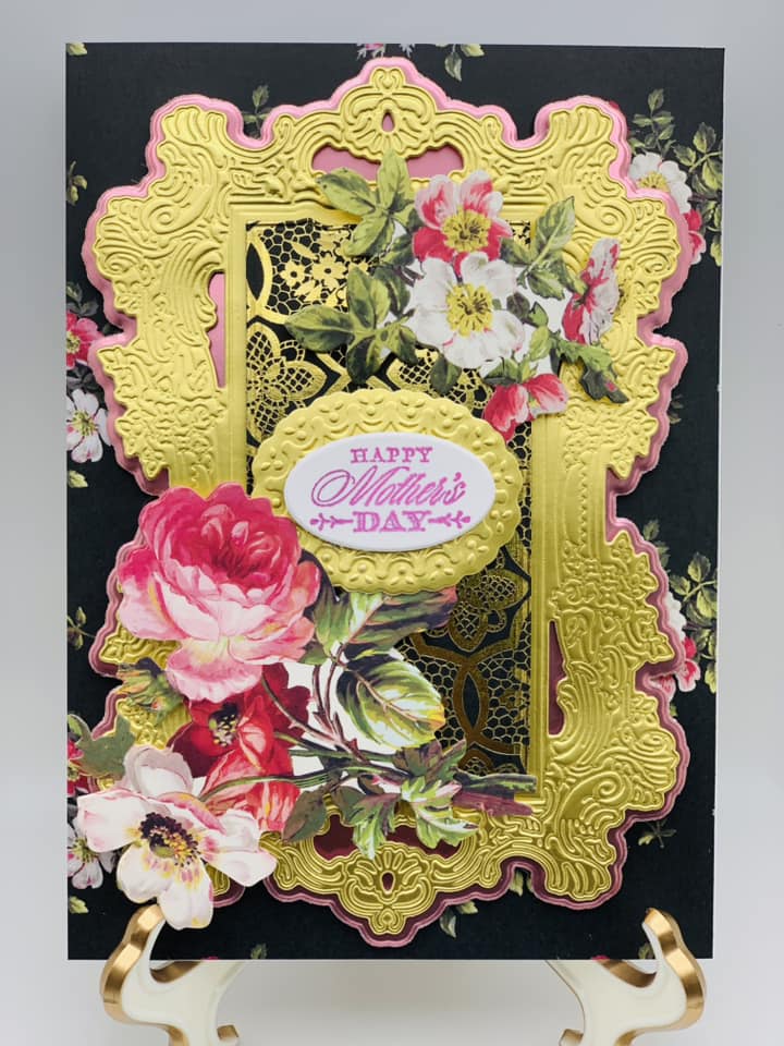 a black and gold card with flowers on it.