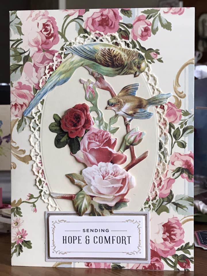 a close up of a card with flowers and birds.