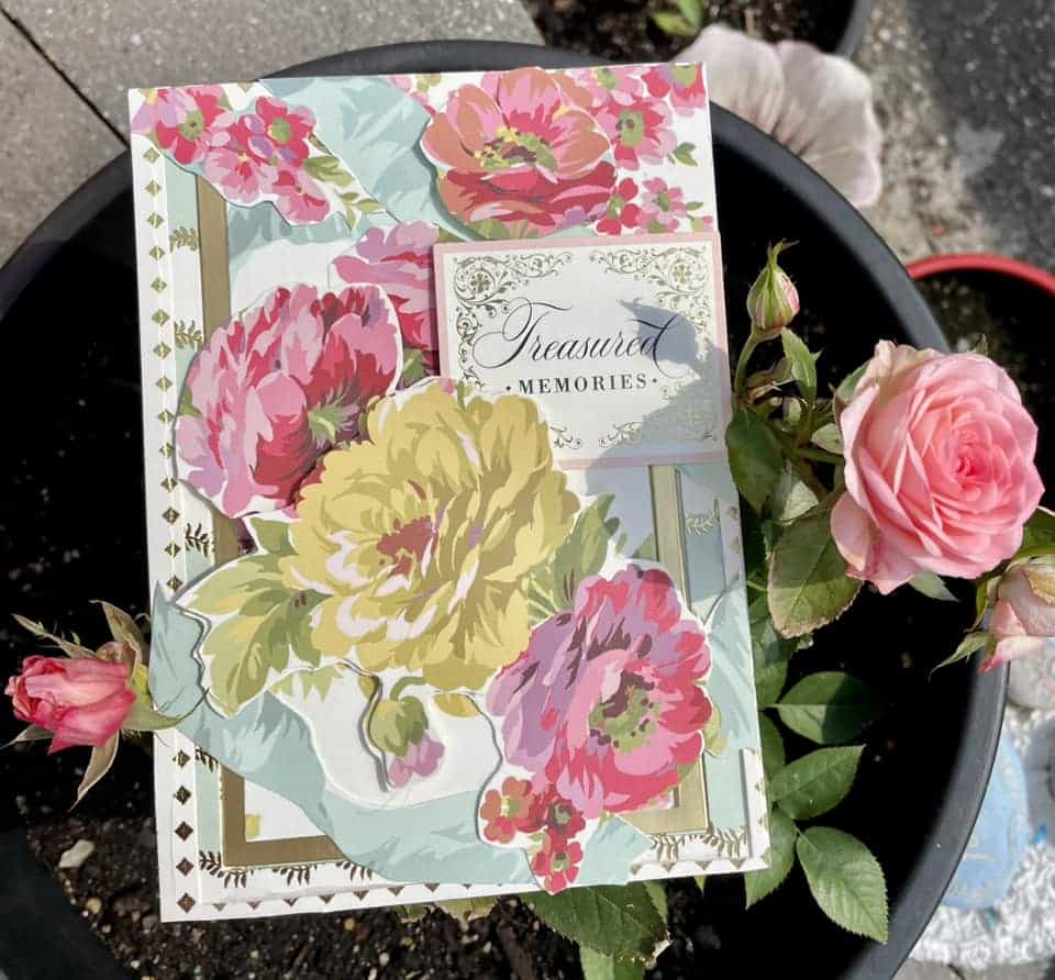 a close up of a flower pot with a card.