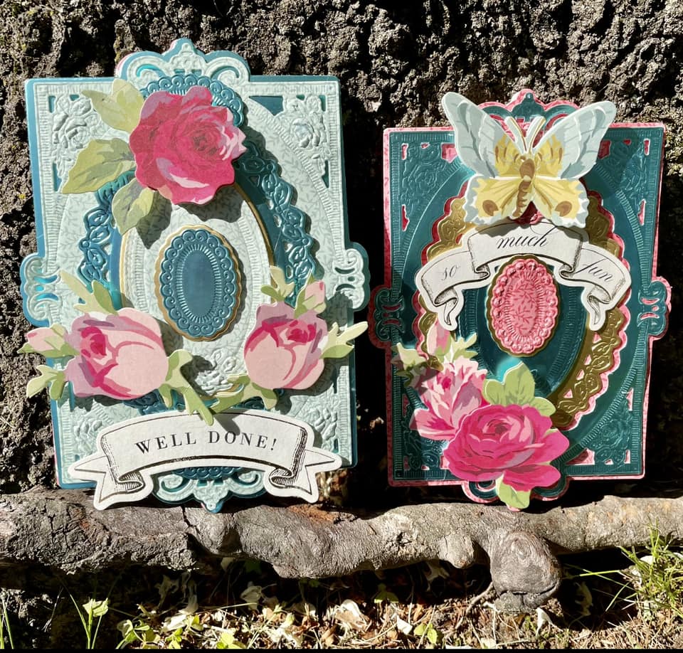 a couple of cards sitting on top of a rock.