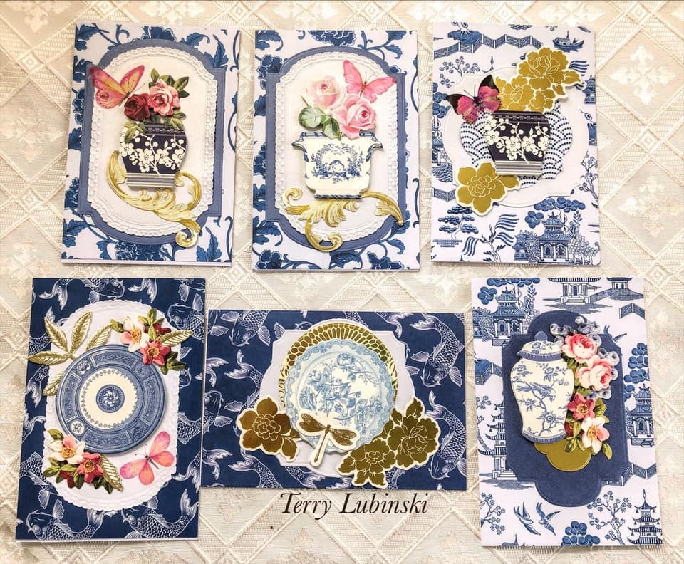 a set of four blue and white cards with flowers.