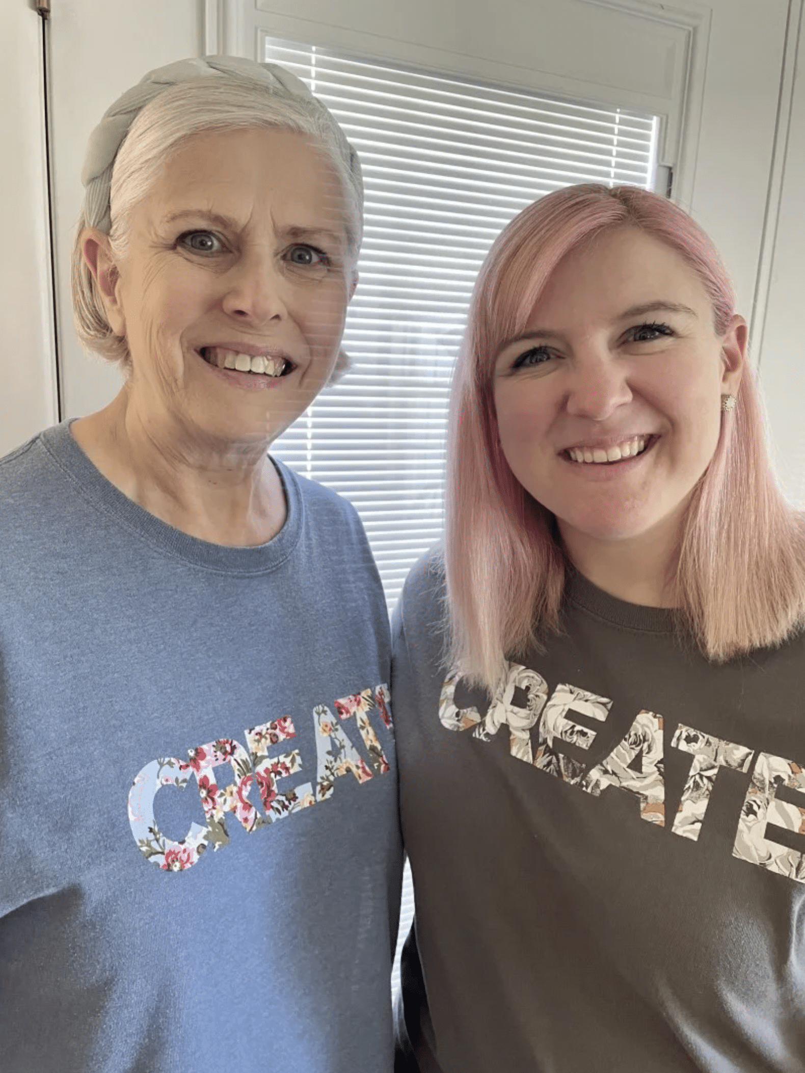 two women standing next to each other smiling.