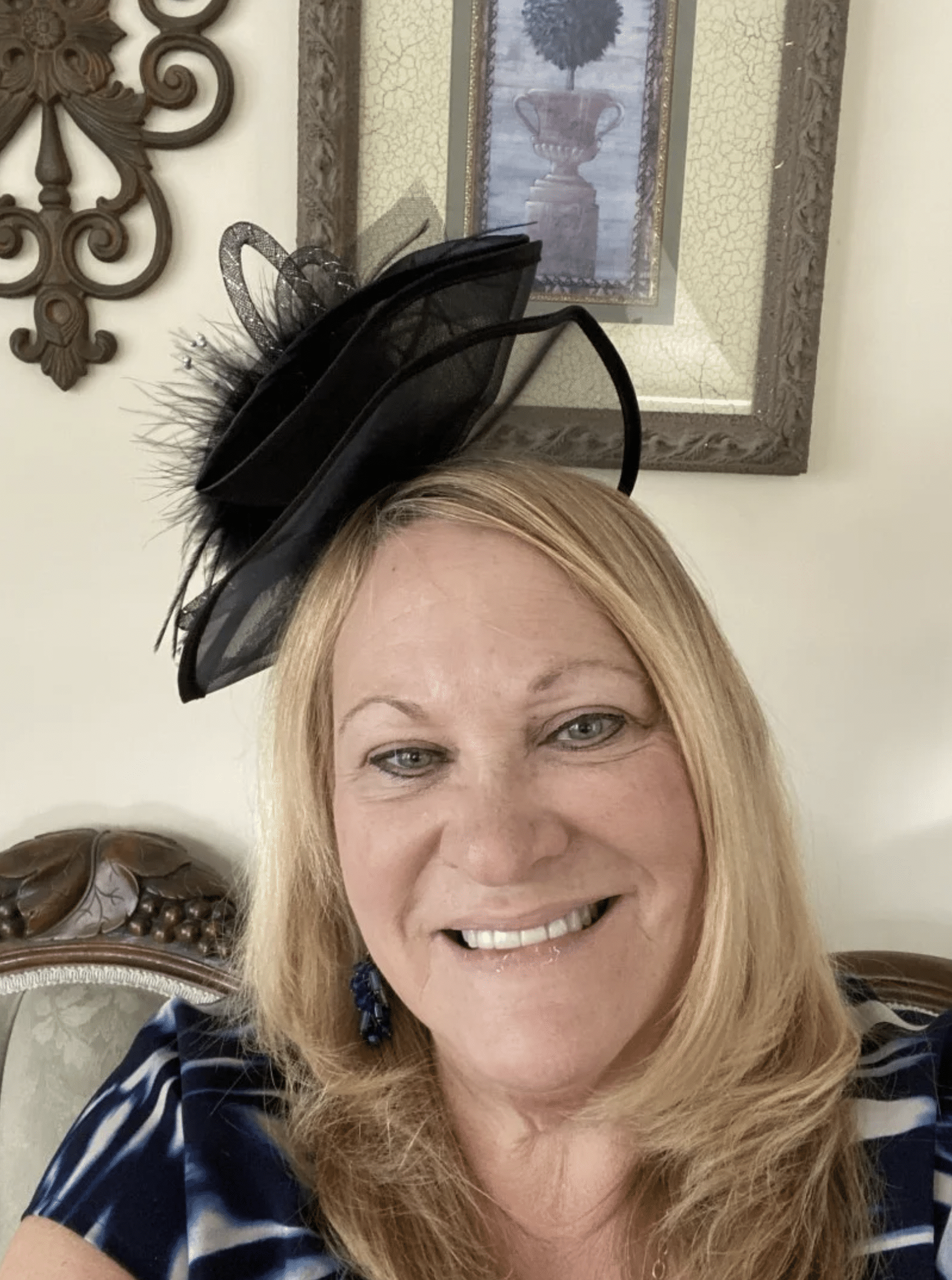 a woman sitting in a chair with a hat on her head.