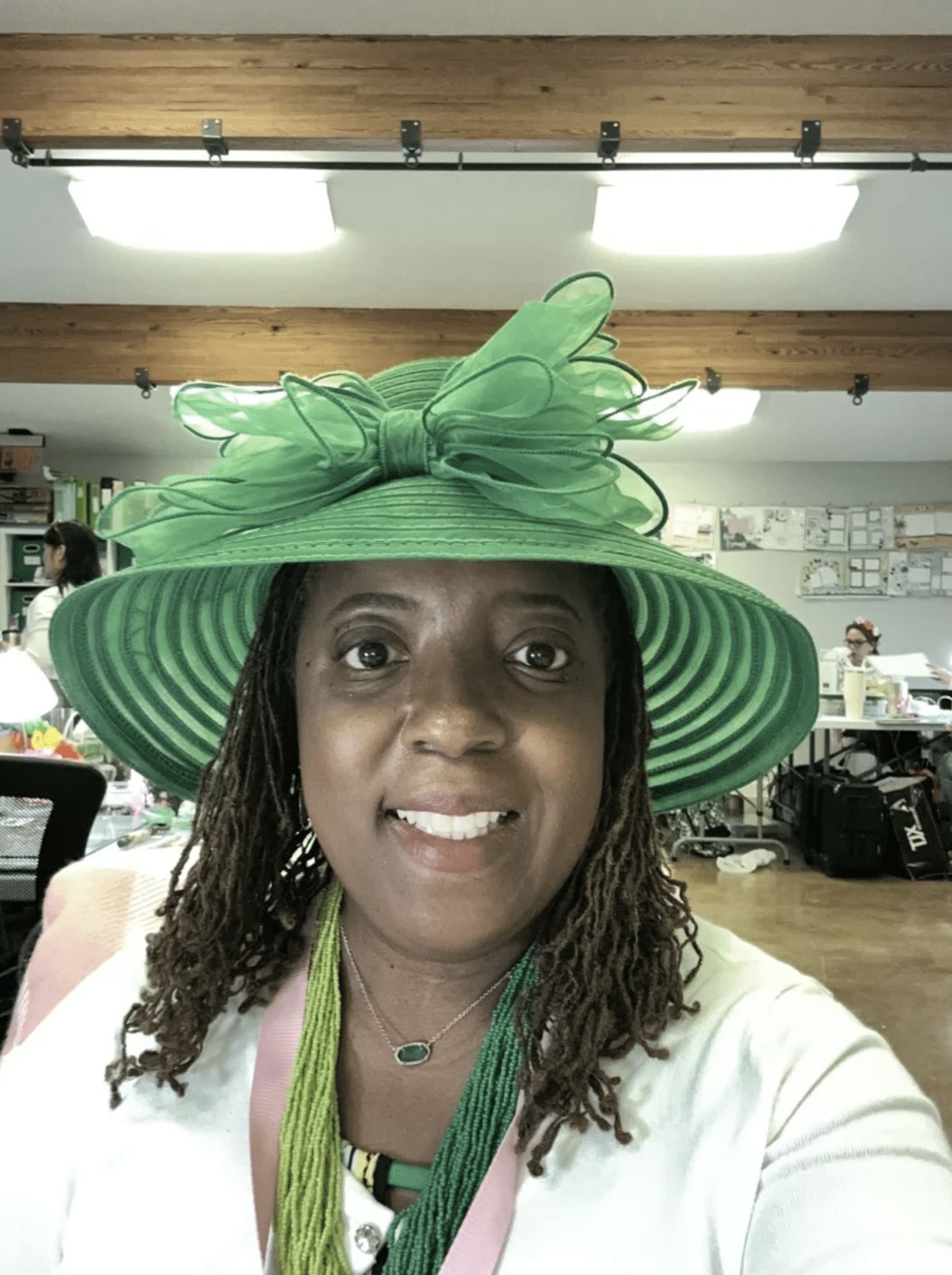 a woman wearing a green hat and a green scarf.