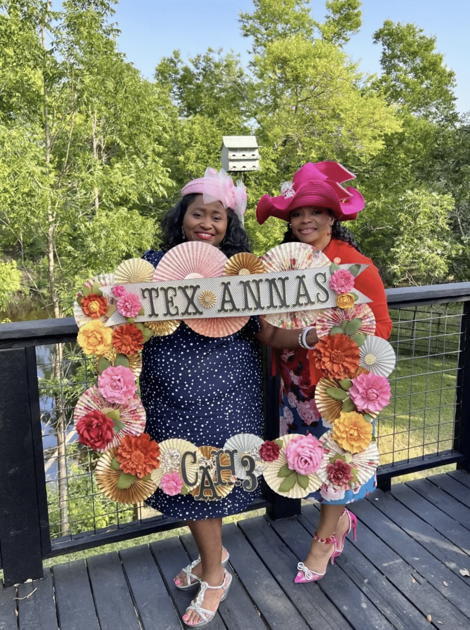 two women standing next to each other on a deck.