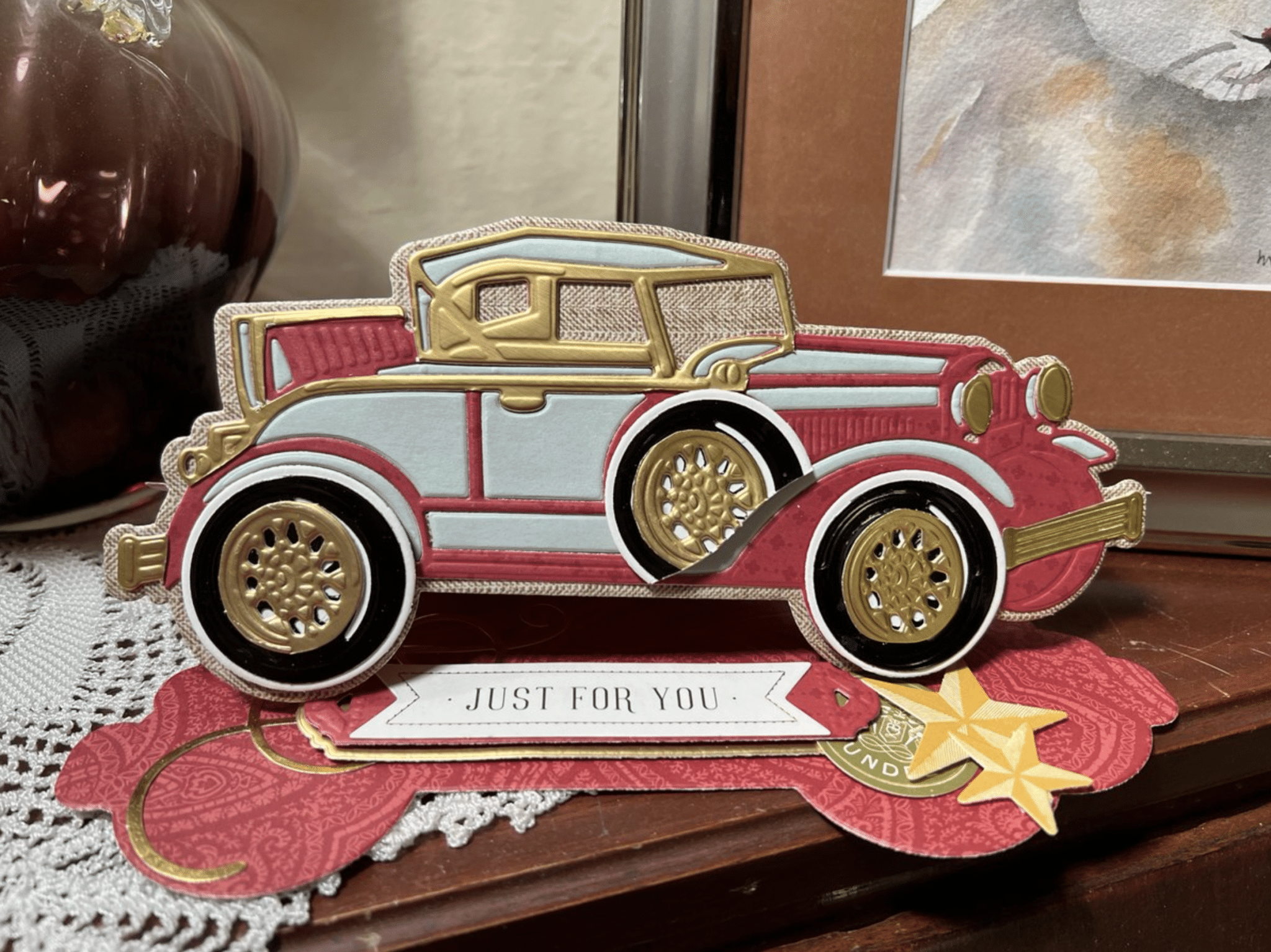 a card with a car on it sitting on a table.