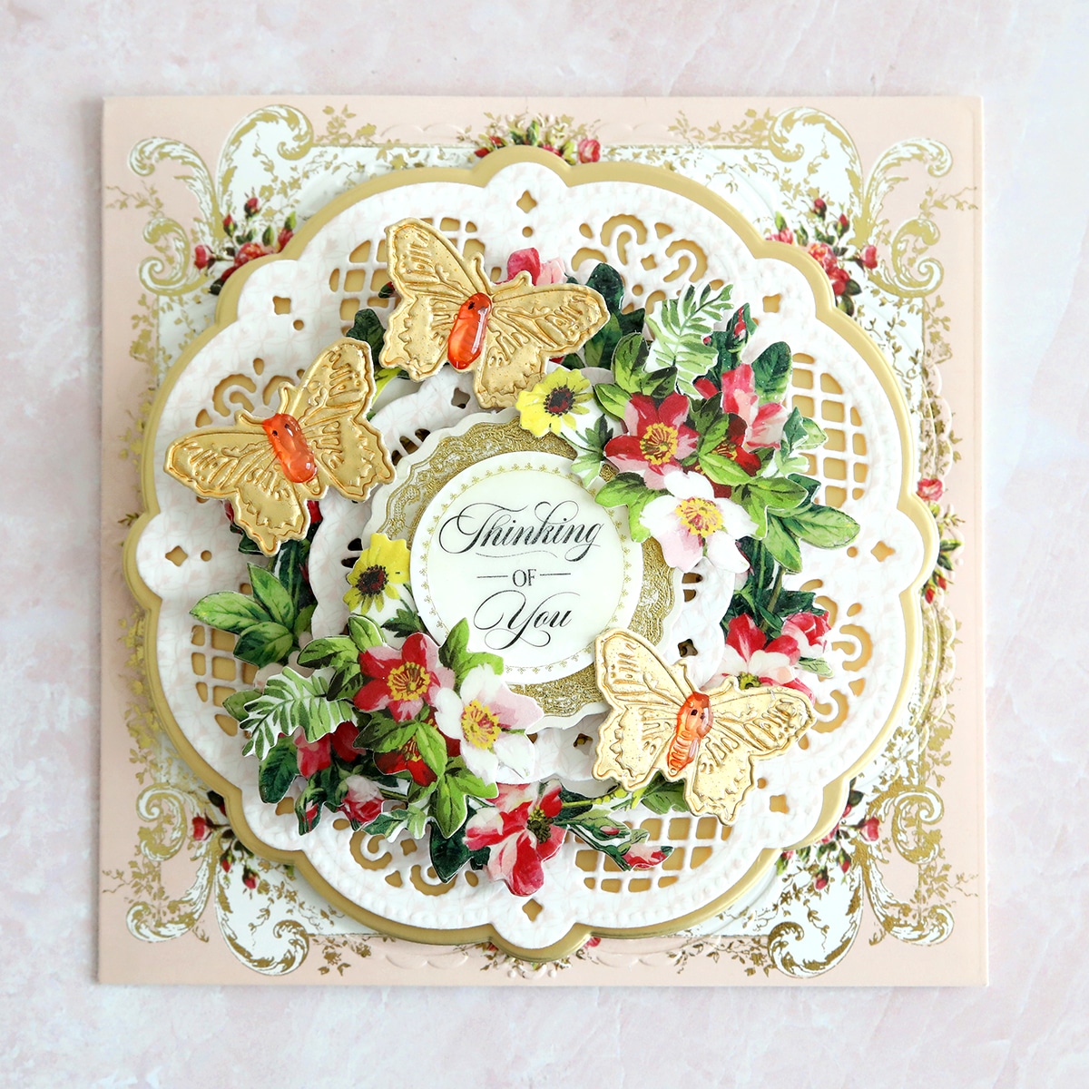 a close up of a card with flowers and butterflies.