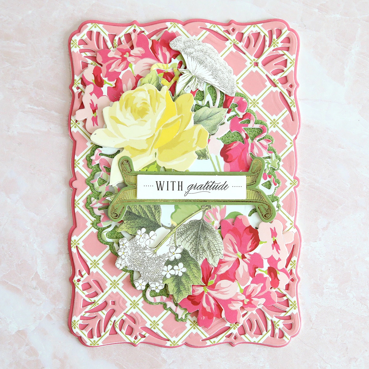 a pink and yellow card with flowers on it.