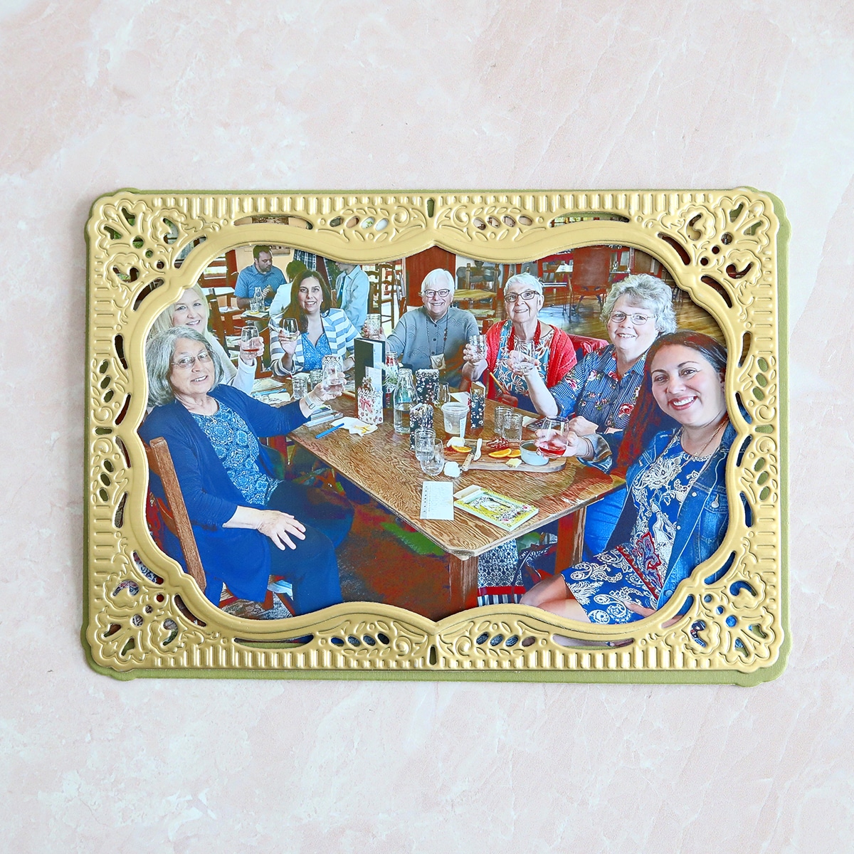 a group of people sitting around a wooden table.