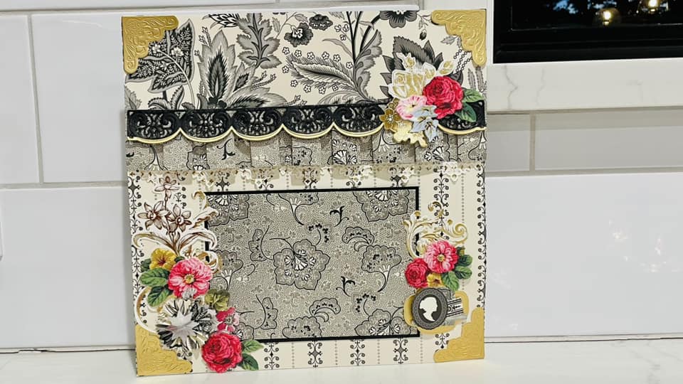 a picture frame decorated with flowers on a kitchen counter.