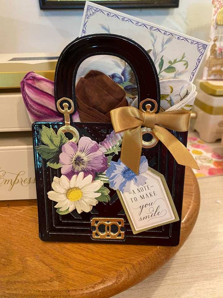 a picture of a purse with flowers and a tag.