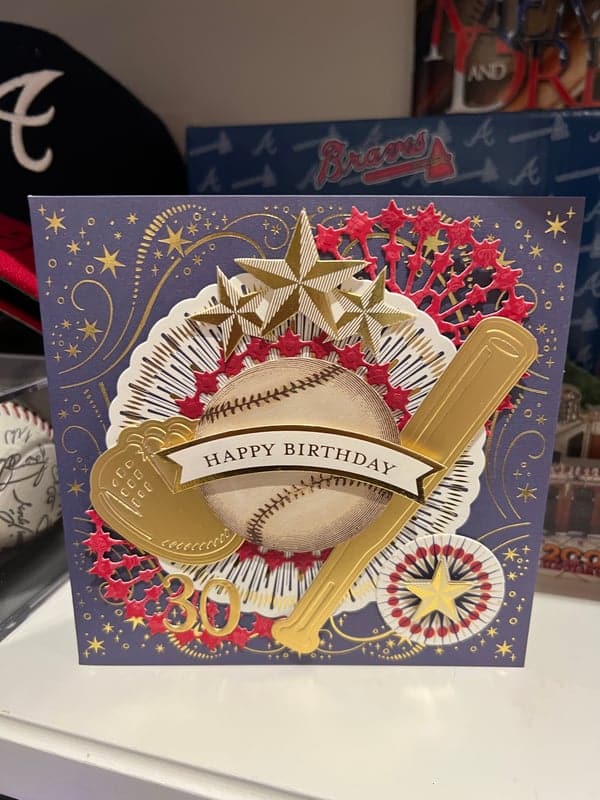 a baseball themed birthday card on a table.