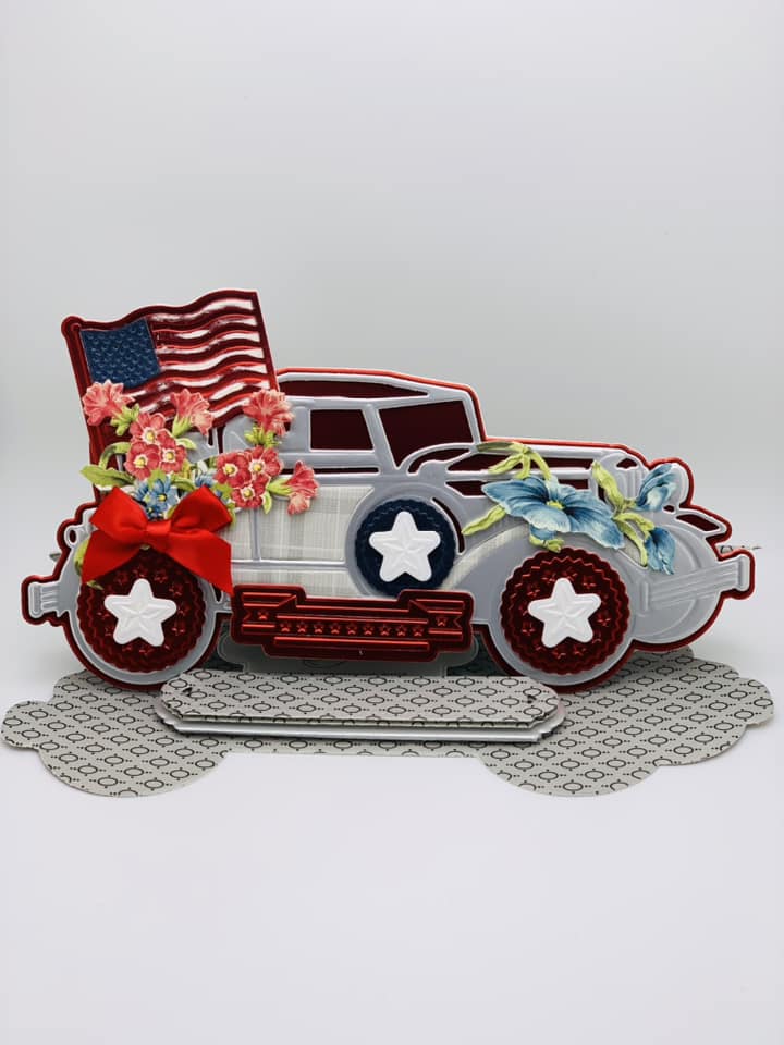 a patriotic card with a vintage car and flowers.