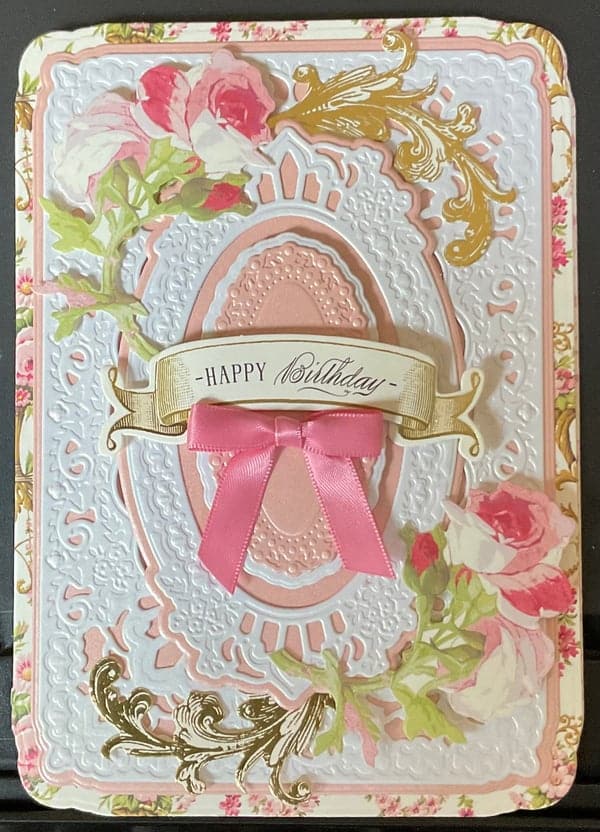 a pink and white birthday card with a pink ribbon.