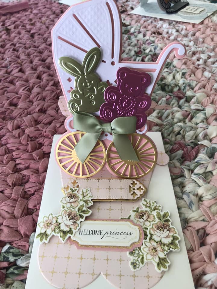 a card with a carriage and flowers on it.