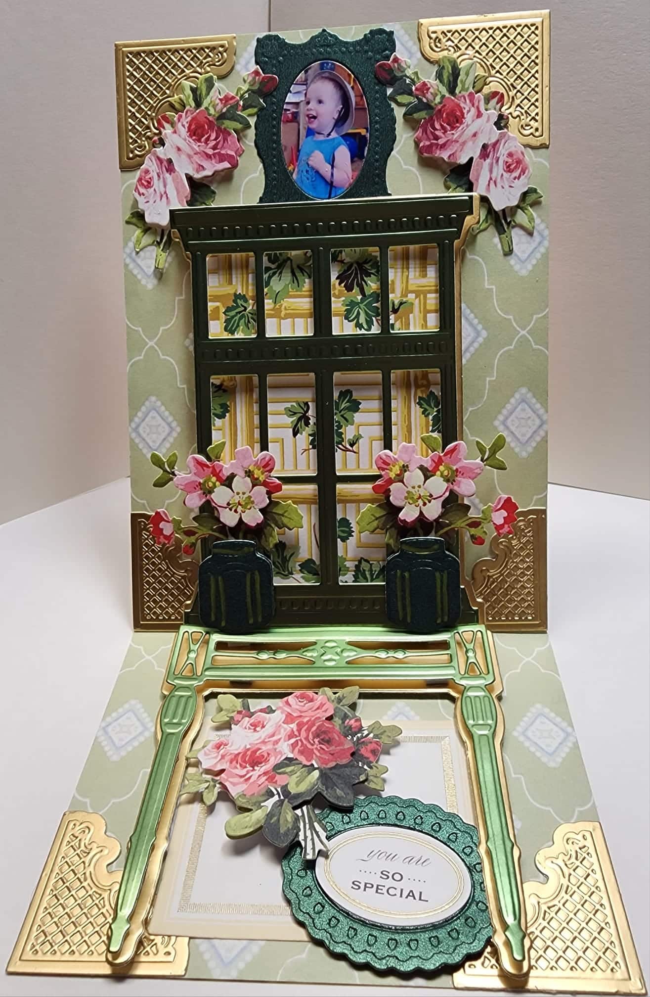 a card with a picture of a window and flowers.