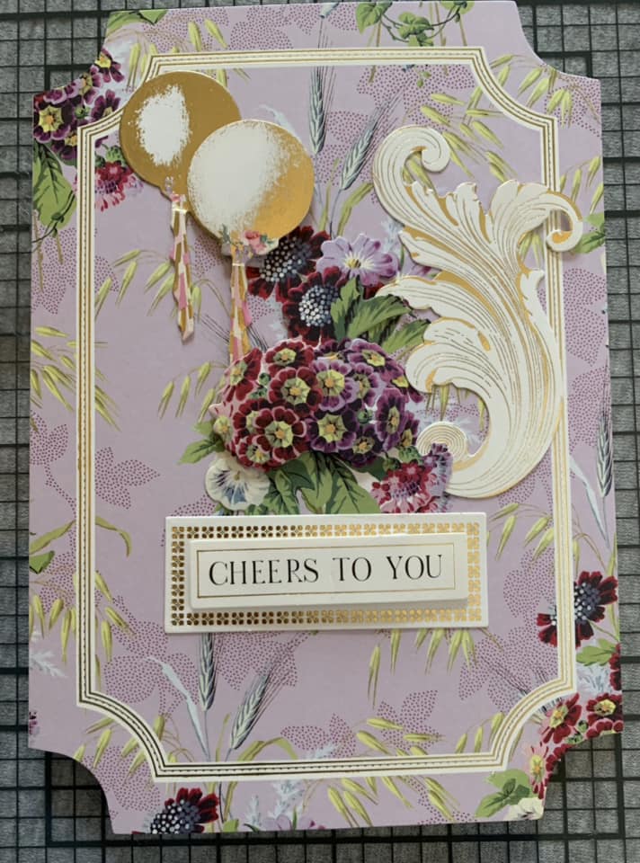 a close up of a card with flowers and a balloon.