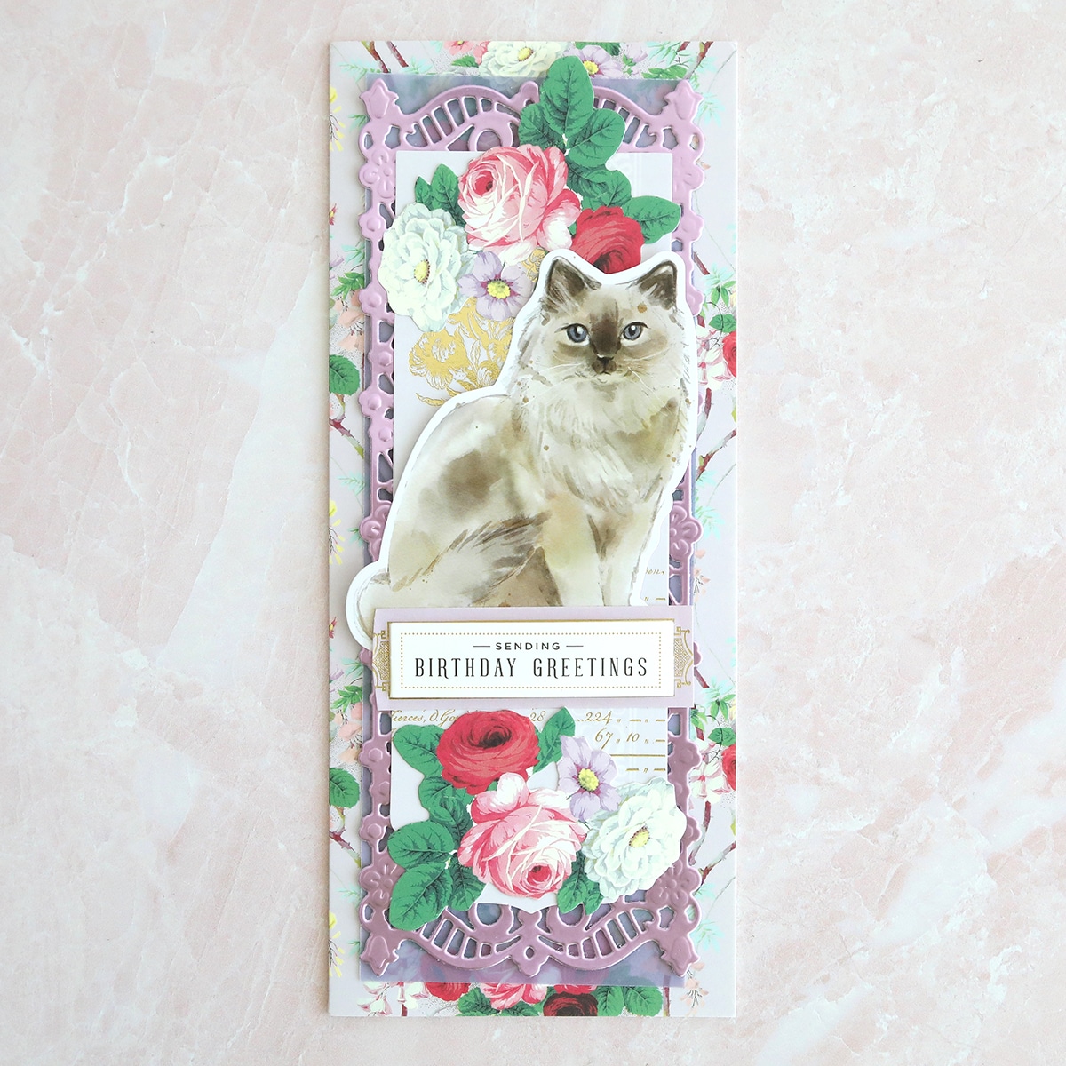 a bookmark with a cat and flowers on it.