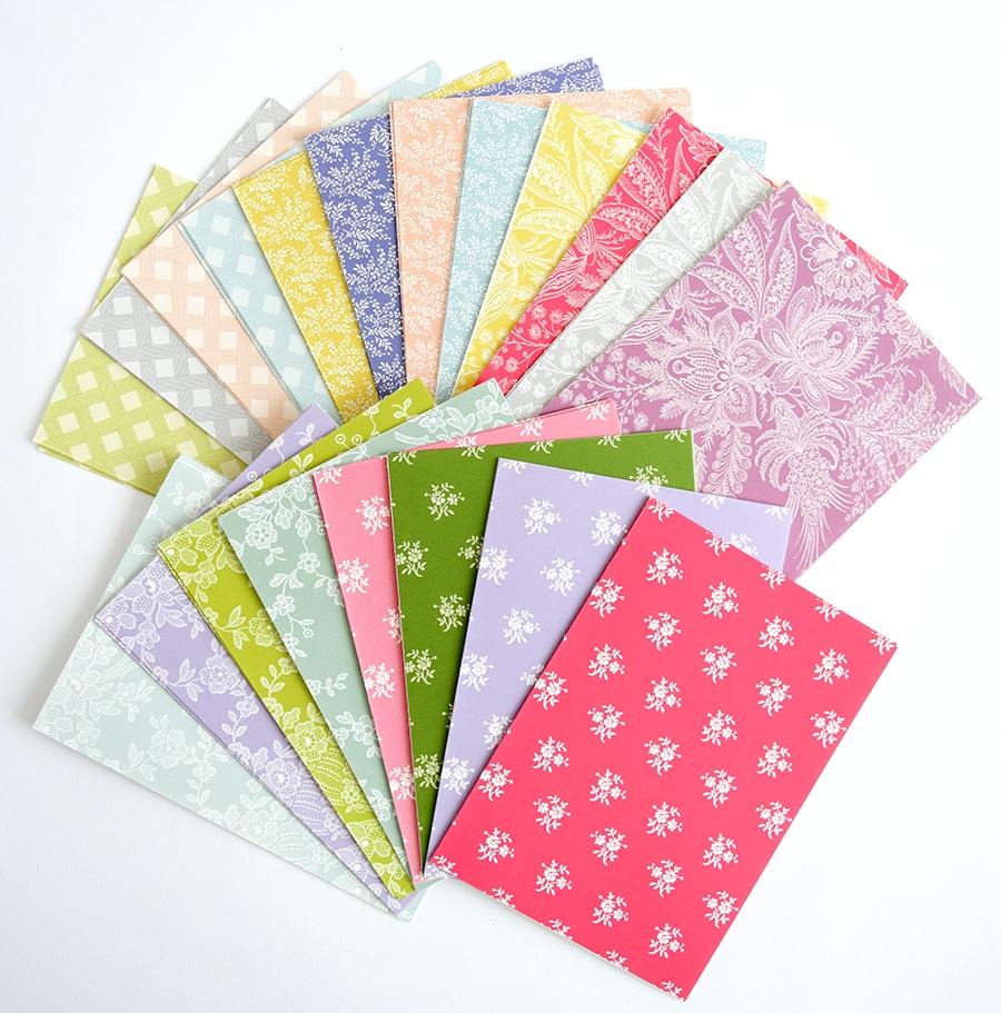 a stack of colorful papers with floral designs.