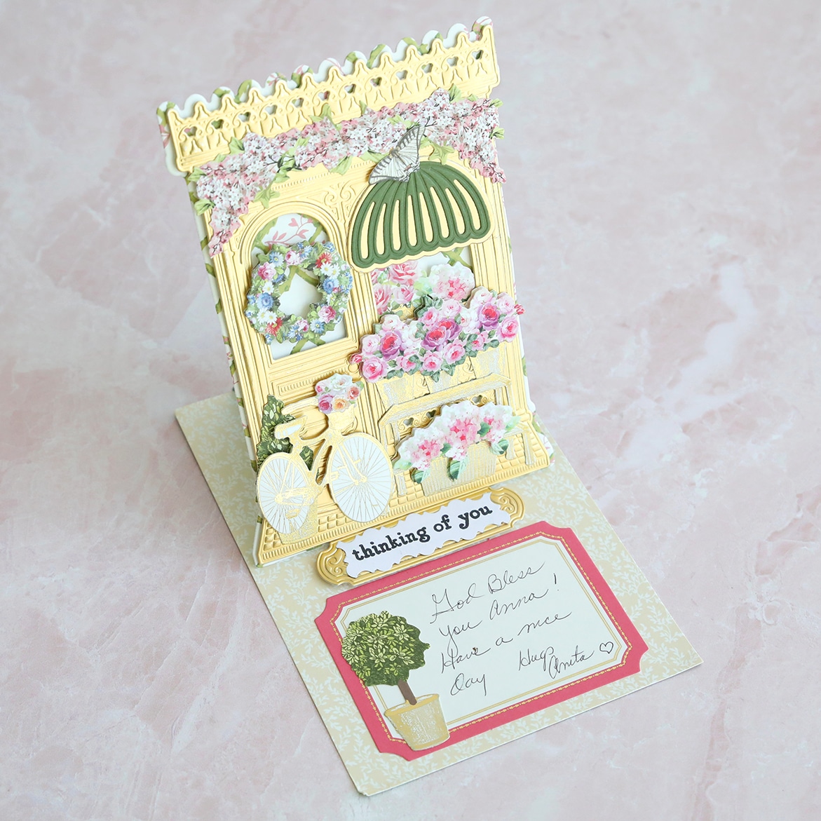 a pop up card with flowers and a note on it.