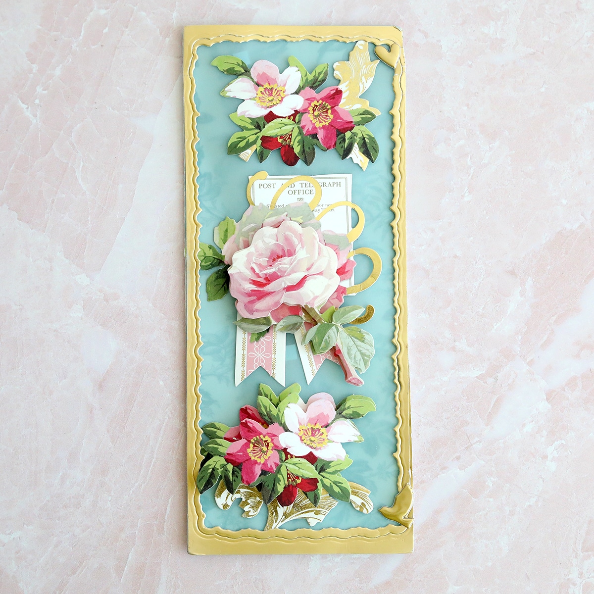 a blue and gold card with flowers on it.