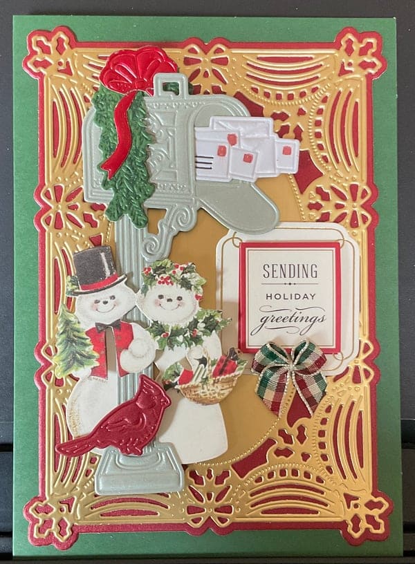 A christmas card with two snowmen and a mailbox.
