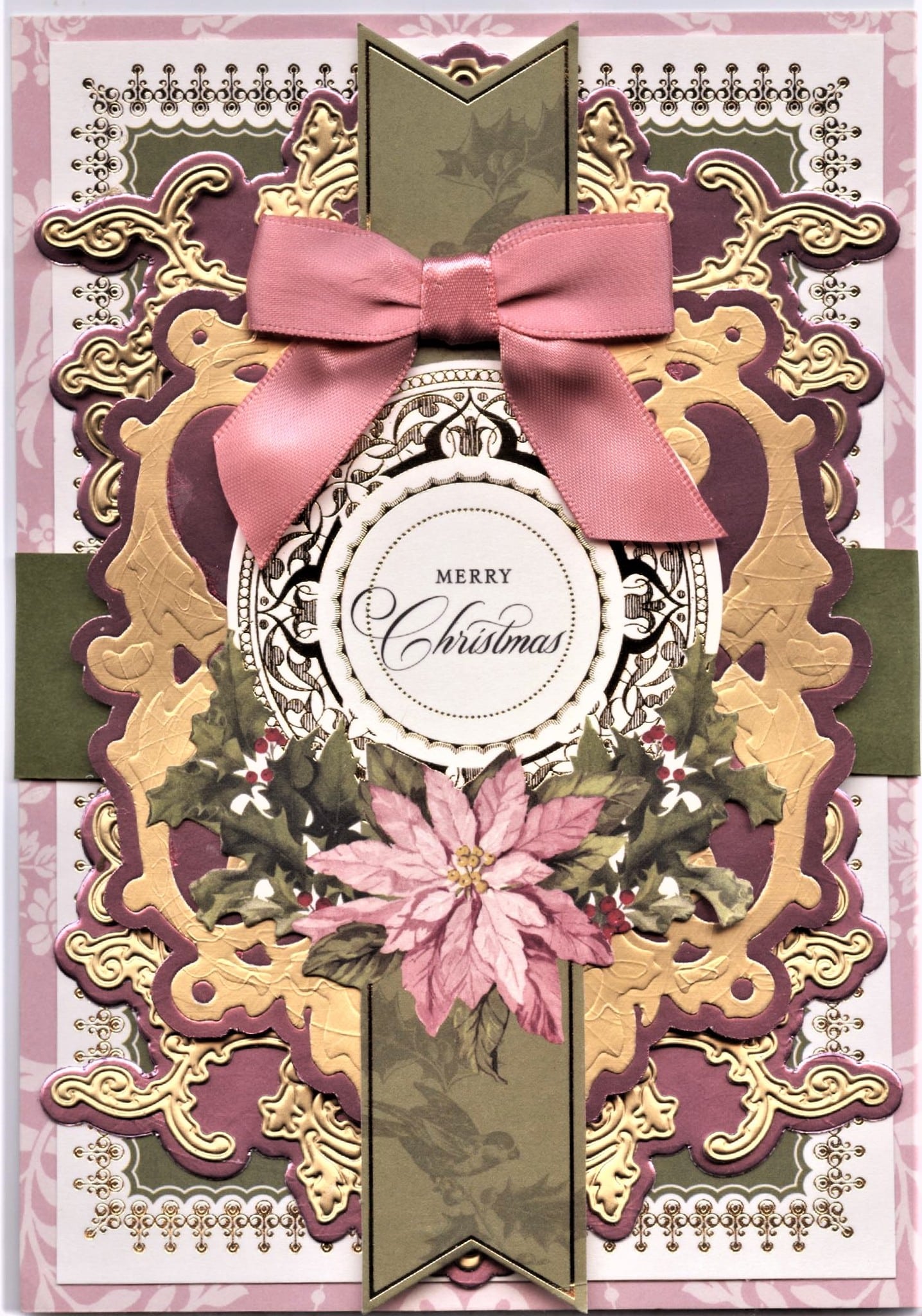A christmas card with a bow and ornaments.