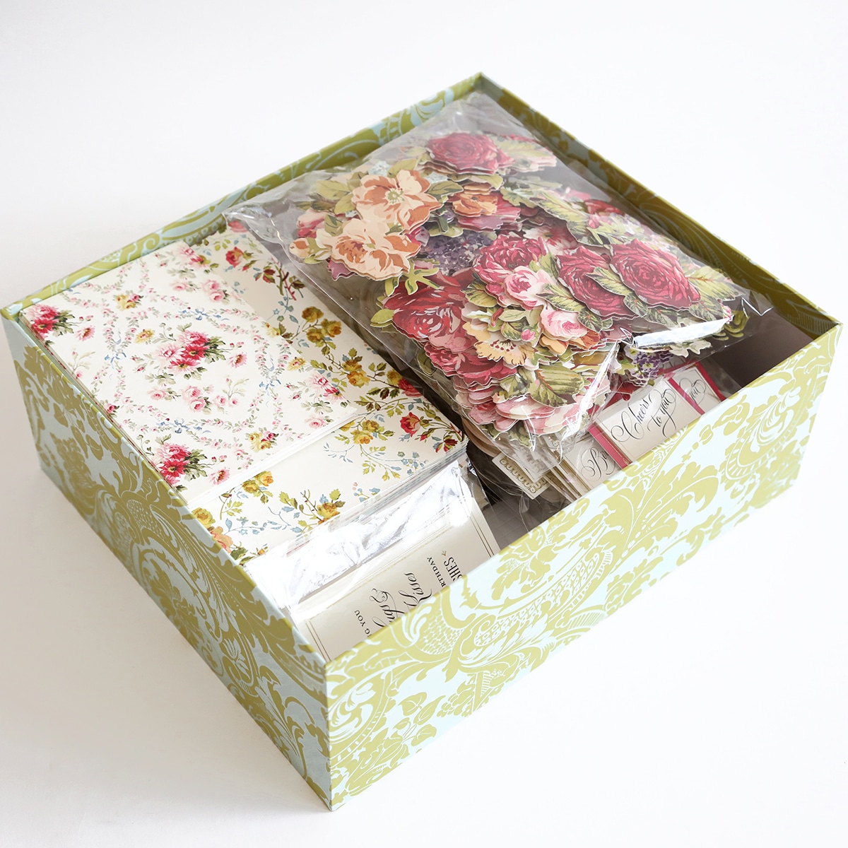 a box filled with flowers and other items.