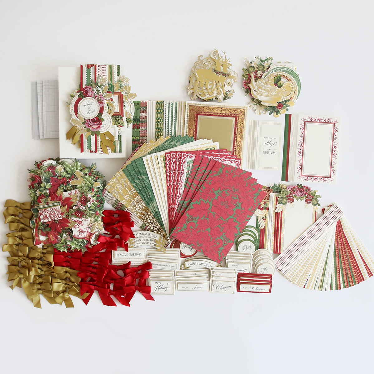 a collection of christmas cards, papers, and ribbons.