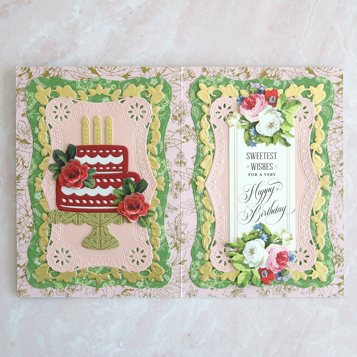 A birthday card with a cake and flowers.