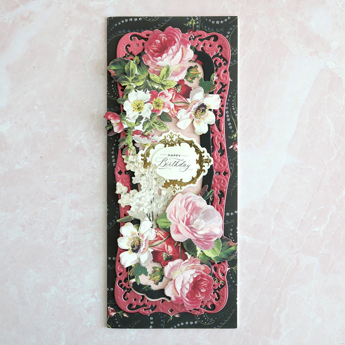 A black and pink card with flowers on it.