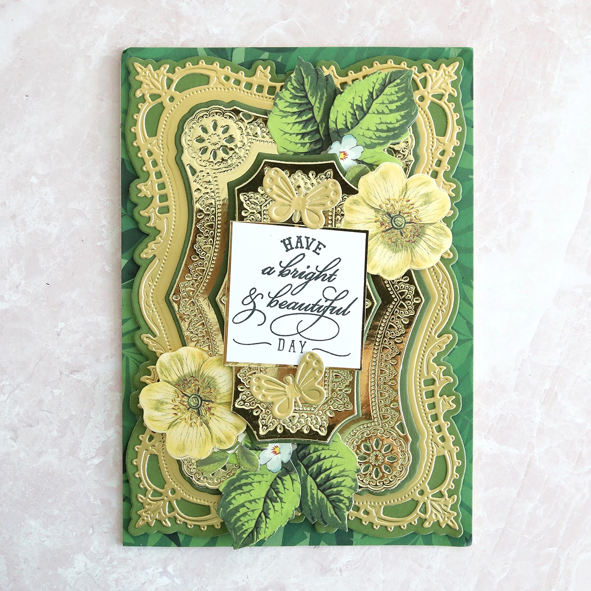 A green card with flowers and leaves on it.