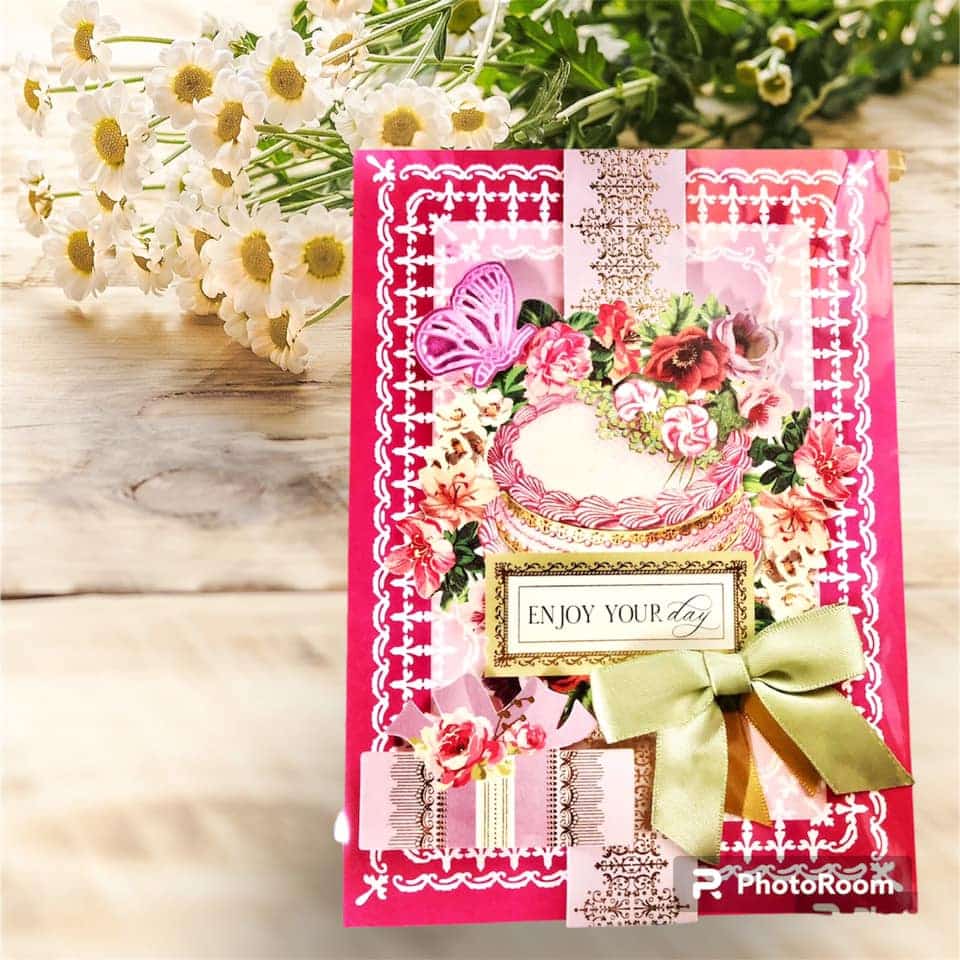 A pink card with flowers on it.