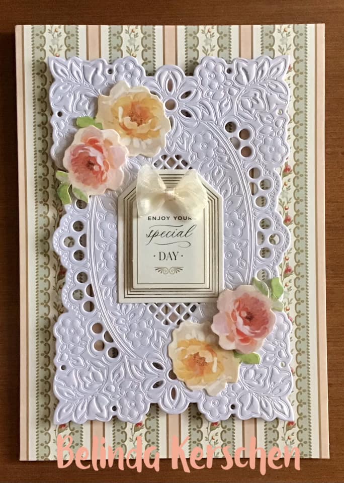 A card with lace and flowers on it.