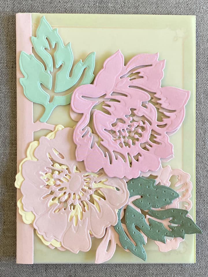 A piece of paper with pink and green flowers on it.