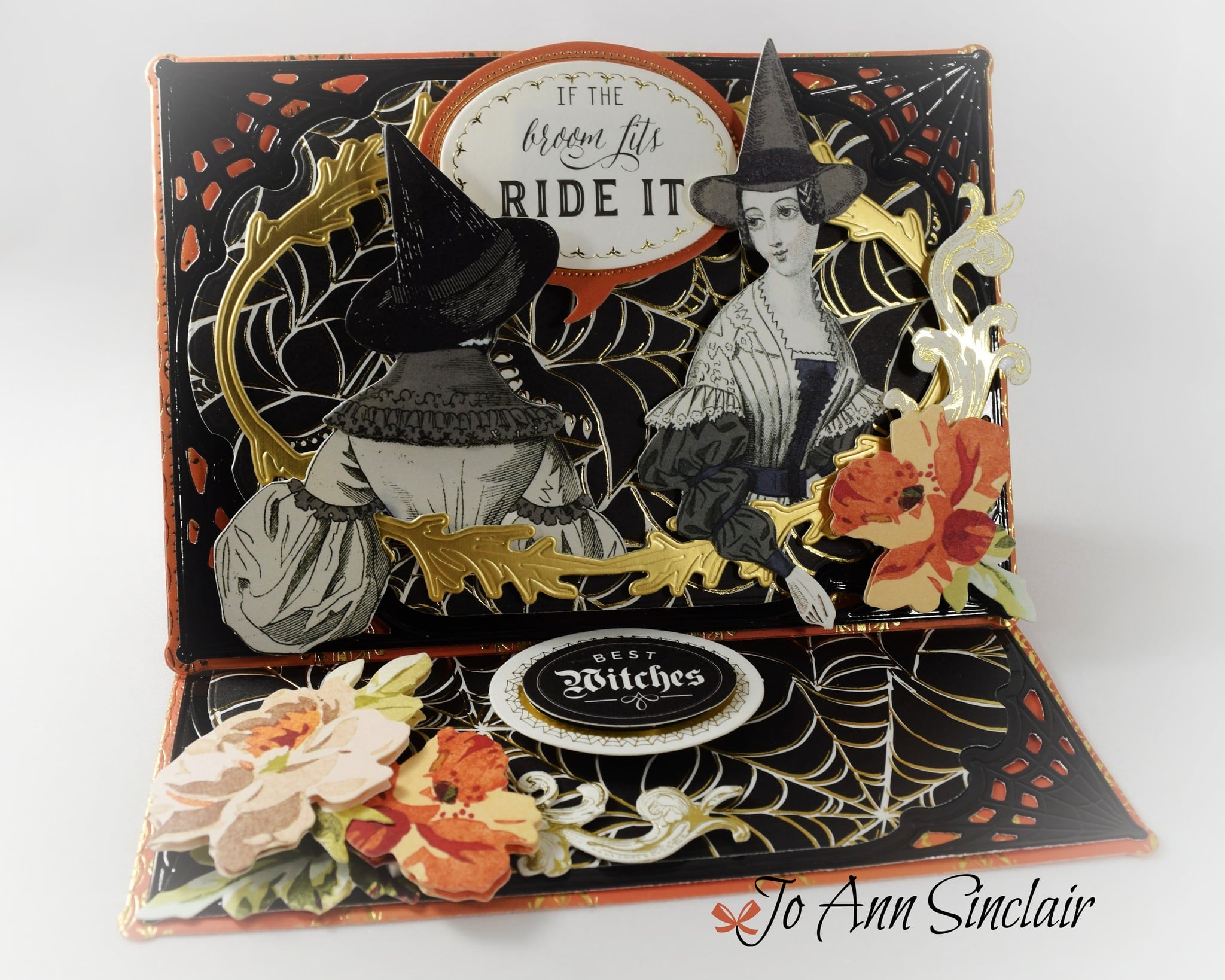 A pop up card with two witches and flowers.