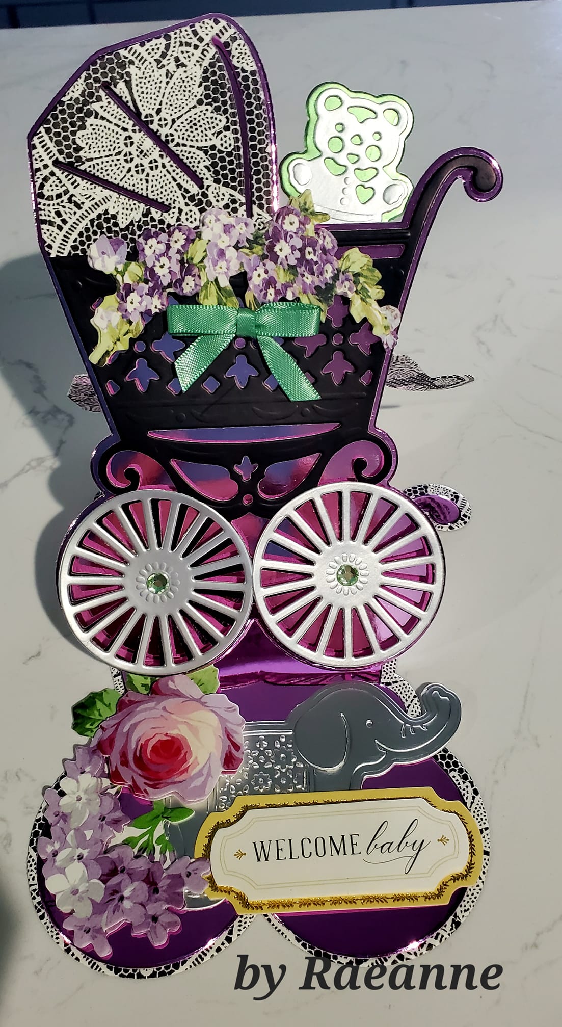 A pop up card with a baby carriage and flowers.