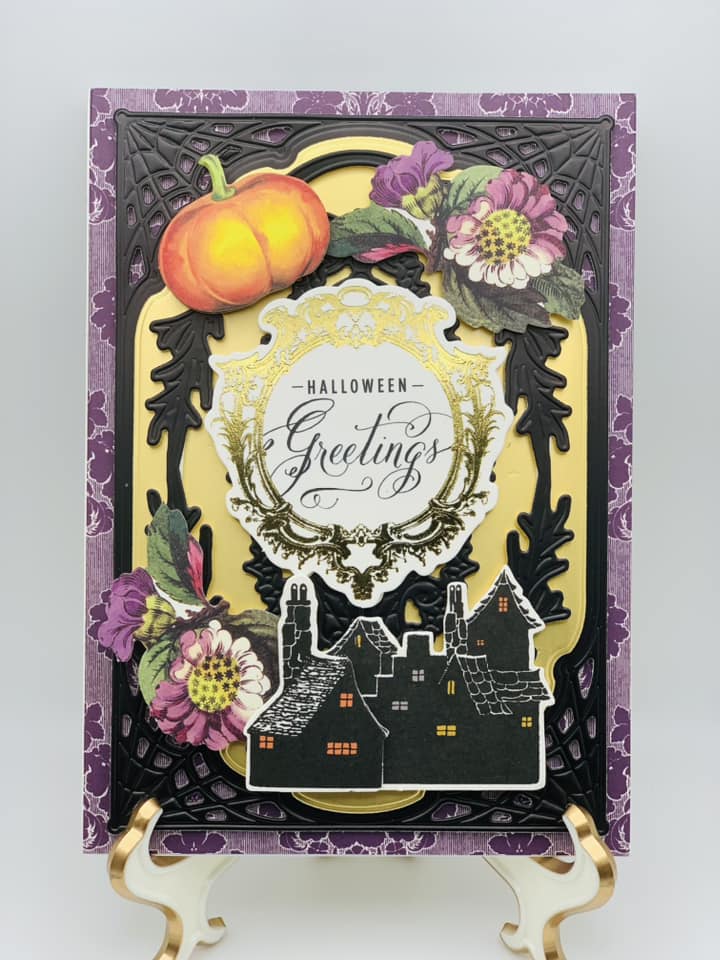 A halloween greeting card with flowers and pumpkins.