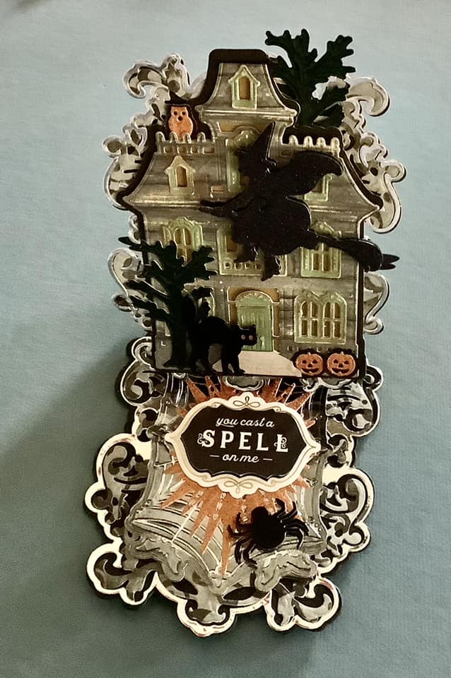 A pop up card with a witch and a house on it.