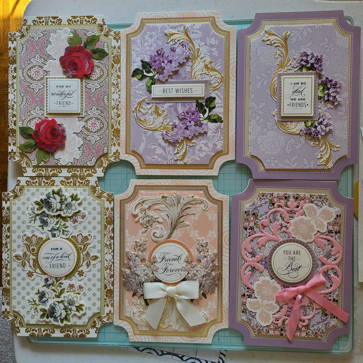 A set of cards with flowers and ribbons on them.